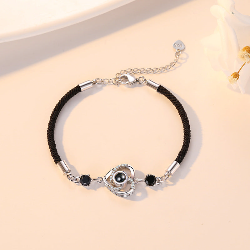 Custom projection bracelet with "I Love You" in 100 languages, perfect for couples. Personalize with engraving for a meaningful gift.