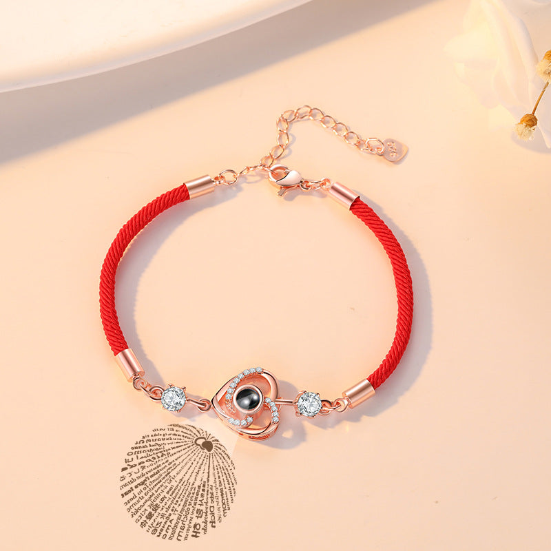 Custom projection bracelet with "I Love You" in 100 languages, perfect for couples. Personalize with engraving for a meaningful gift.