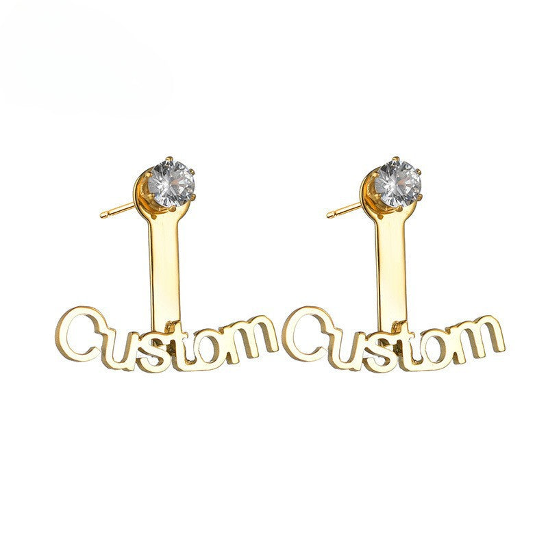 Trendy stainless steel name stud earrings with diamond accents and cut-out letter design.