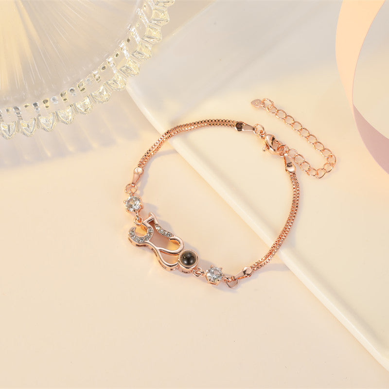 Customizable couple bracelets with engraving and "100 languages I love you" projection, perfect for gifting.
