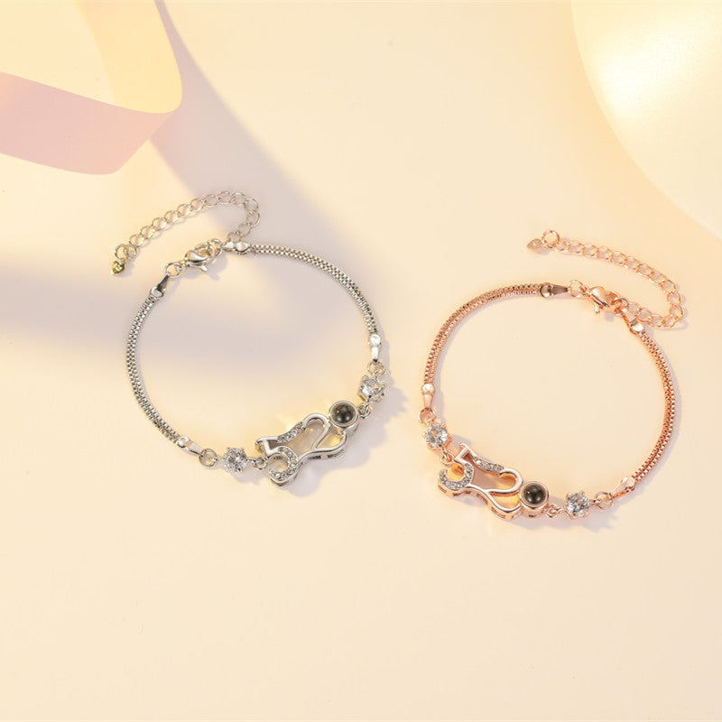Customizable couple bracelets with engraving and "100 languages I love you" projection, perfect for gifting.