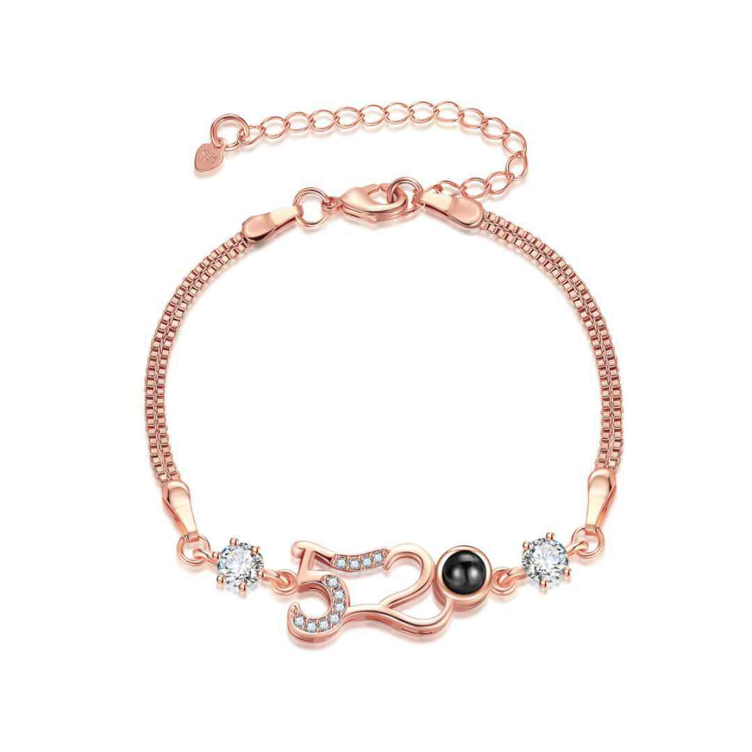 Customizable couple bracelets with engraving and "100 languages I love you" projection, perfect for gifting.