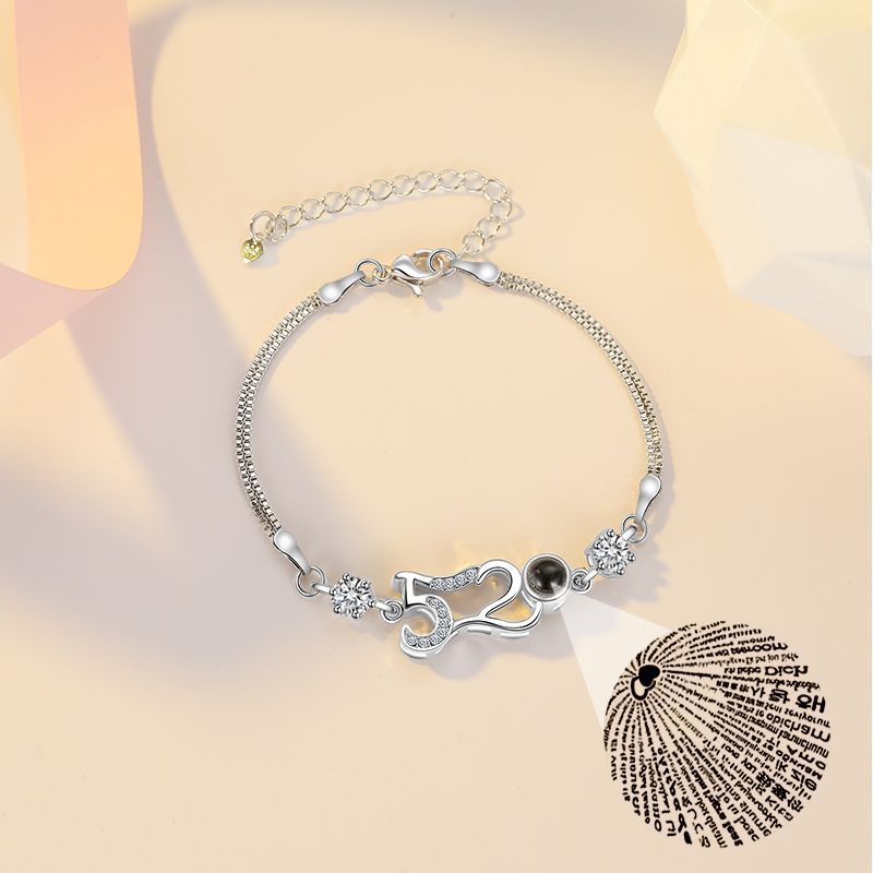 Customizable couple bracelets with engraving and "100 languages I love you" projection, perfect for gifting.