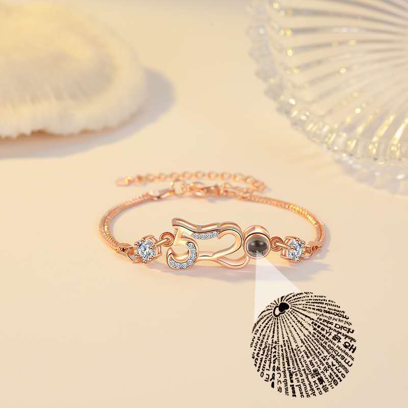 Customizable couple bracelets with engraving and "100 languages I love you" projection, perfect for gifting.