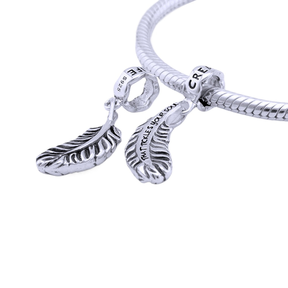 Elegant 925 sterling silver bracelet with feather pendant and zircon beads. High-quality, minimalist design.