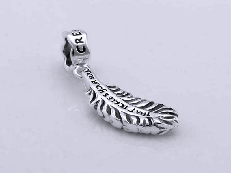 Elegant 925 sterling silver bracelet with feather pendant and zircon beads. High-quality, minimalist design.