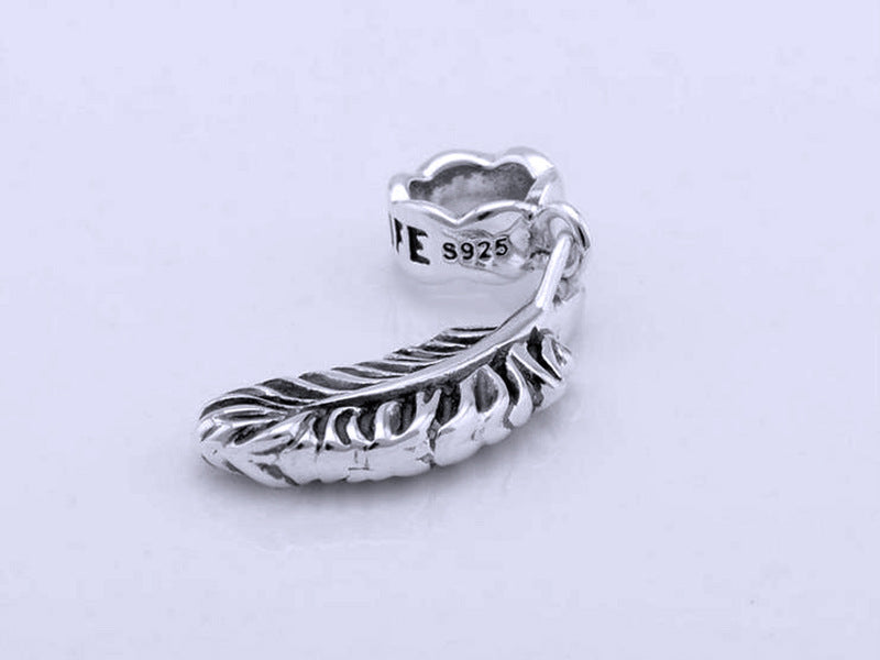 Elegant 925 sterling silver bracelet with feather pendant and zircon beads. High-quality, minimalist design.