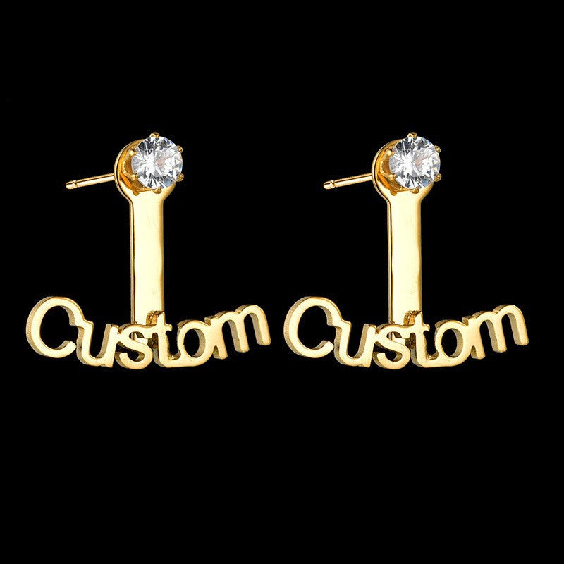 Trendy stainless steel name stud earrings with diamond accents and cut-out letter design.