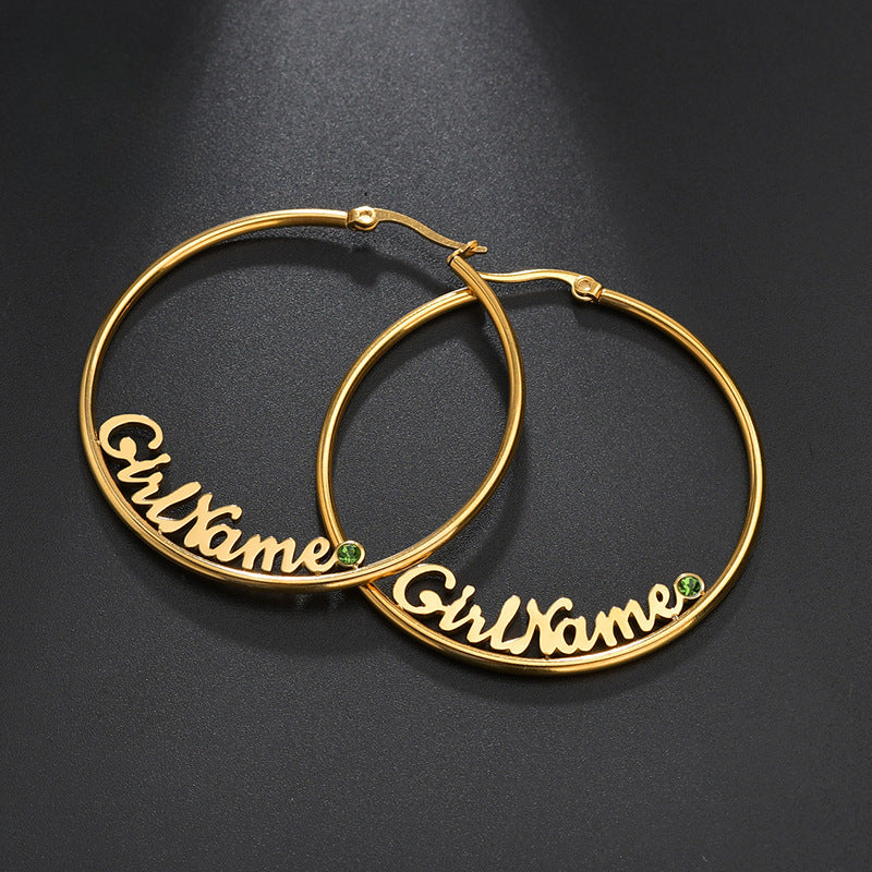 Hot-selling large round stainless steel letter name hoop earrings with rhinestone accents for women.