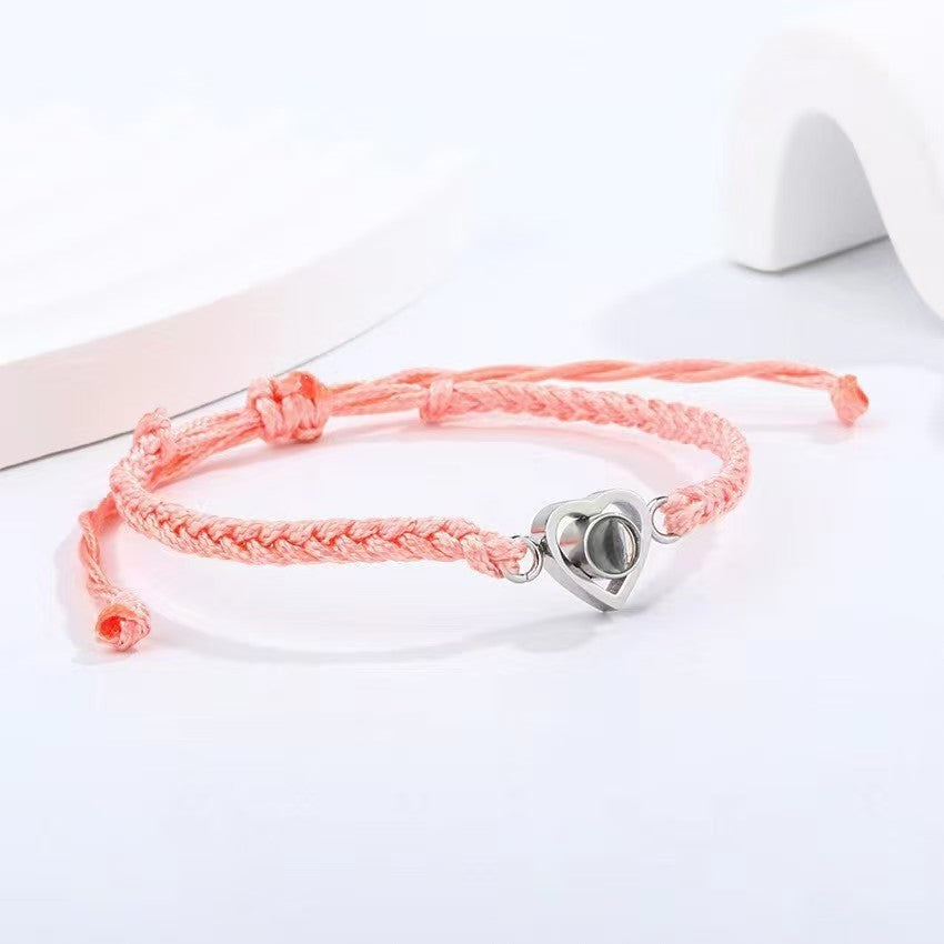 Popular heart woven bracelet with "I love you" in 100 languages projection, Korean-style minimalist design.