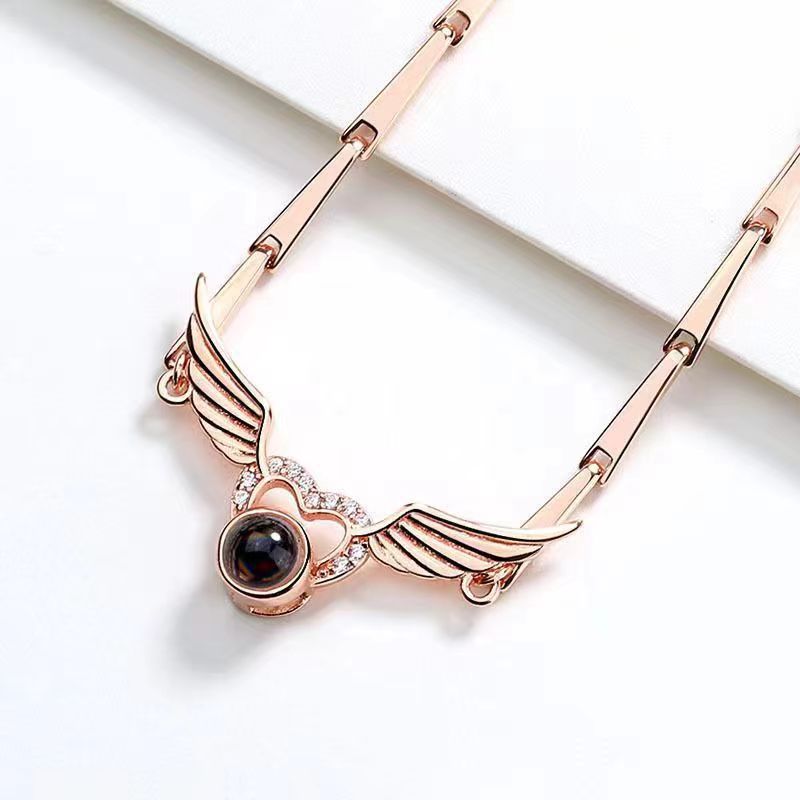 Hot-selling "I Love You" in 100 languages bracelet with crystal heart and wing design.