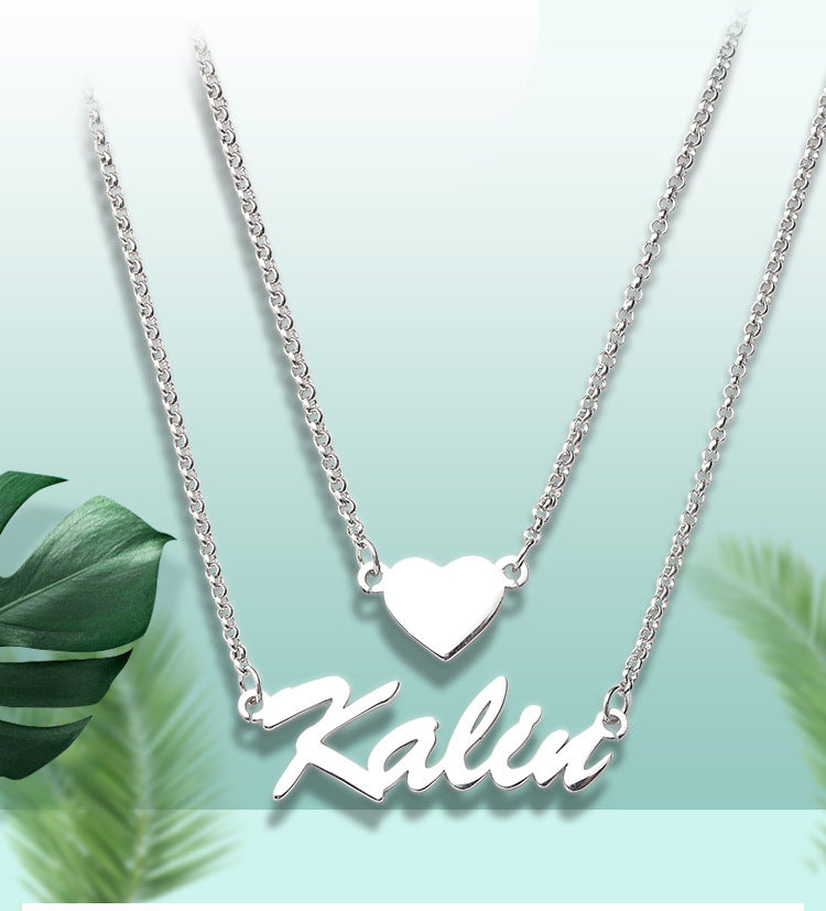 Custom heart-shaped double pendant necklace with personalized name lettering in silver. Stylish
