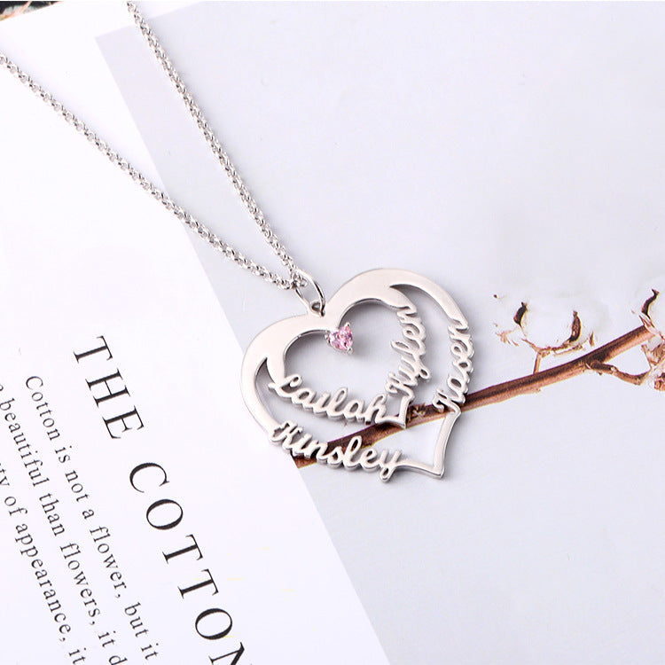 Custom geometric heart-shaped diamond necklace with creative lettering. Fashionable claw pendant on a silver chain, perfect for collarbone jewelry. Available for wholesale.