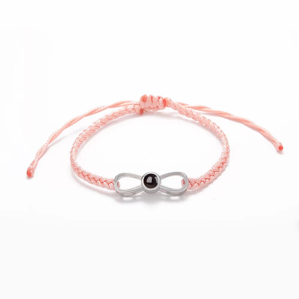 Korean-style bow braided bracelet with 100-language "I love you" photo projection, customizable for couples.