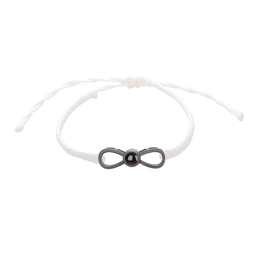 Korean-style bow braided bracelet with 100-language "I love you" photo projection, customizable for couples.