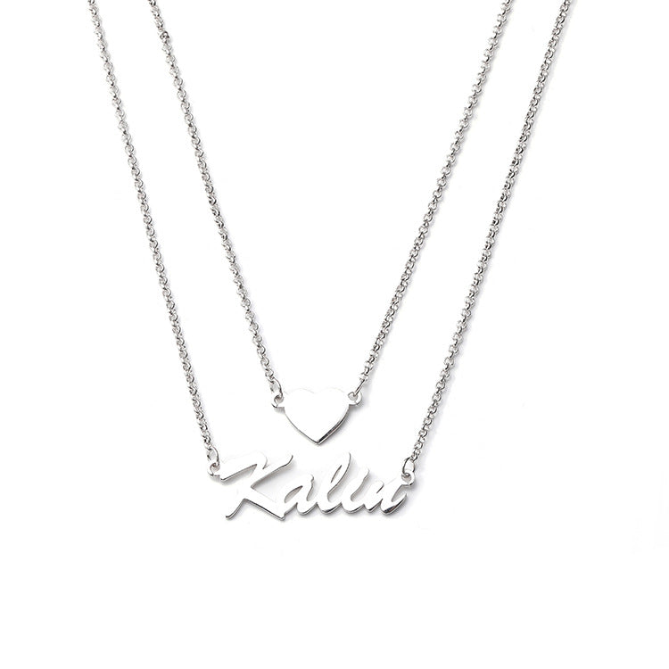 Custom heart-shaped double pendant necklace with personalized name lettering in silver. Stylish