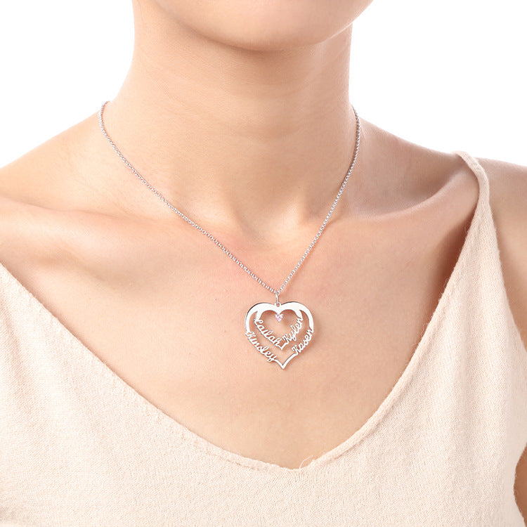 Custom geometric heart-shaped diamond necklace with creative lettering. Fashionable claw pendant on a silver chain, perfect for collarbone jewelry. Available for wholesale.