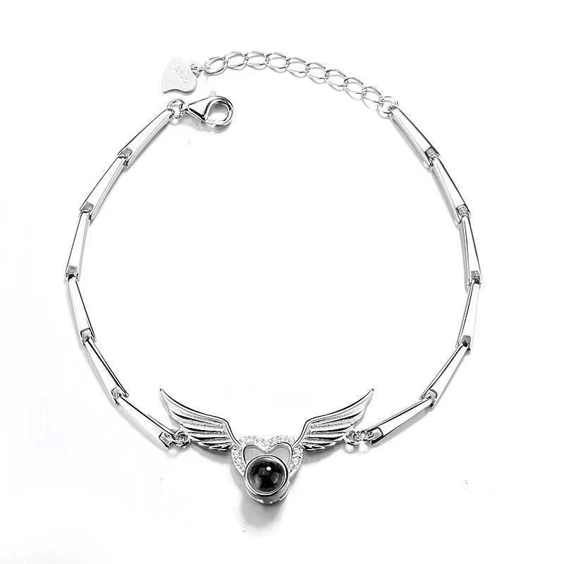 Hot-selling "I Love You" in 100 languages bracelet with crystal heart and wing design.