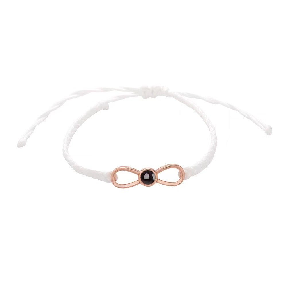 Korean-style bow braided bracelet with 100-language "I love you" photo projection, customizable for couples.