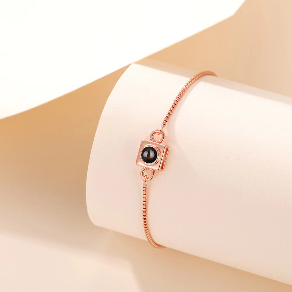 Trending square box sliding bracelet with photo projection and "I love you" in 100 languages.