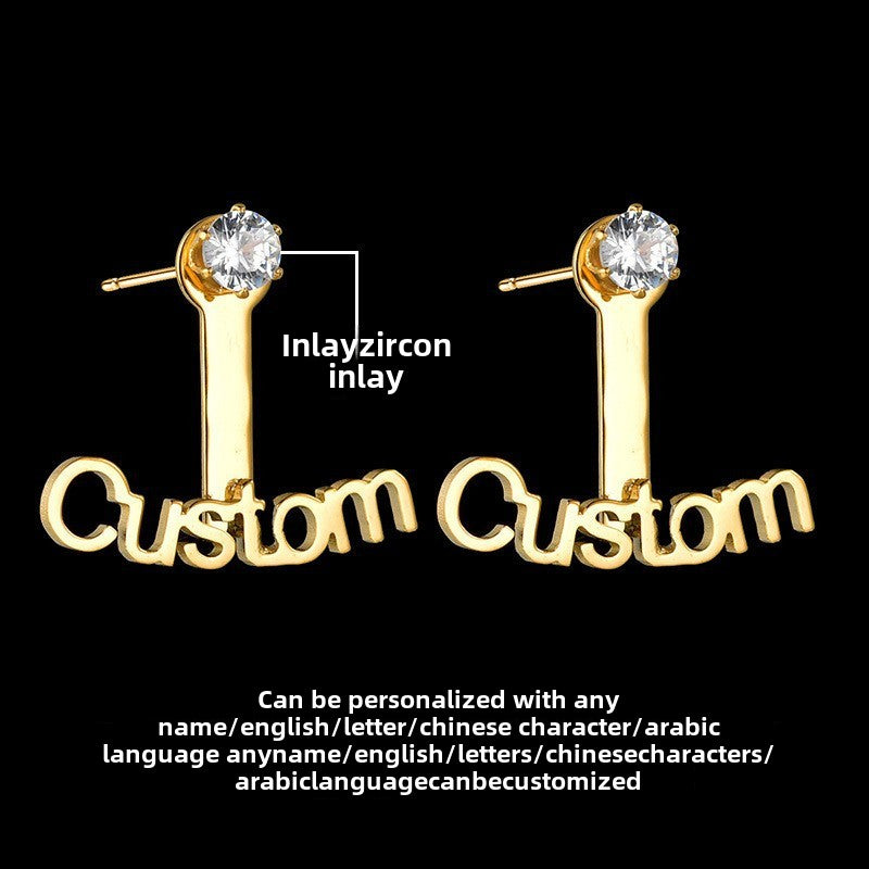Trendy stainless steel name stud earrings with diamond accents and cut-out letter design.