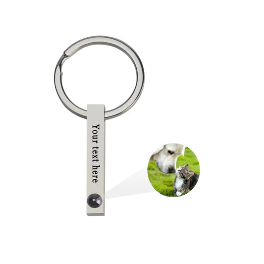 Customized titanium steel keychain with photo projection, available in 100 languages and colorfast.